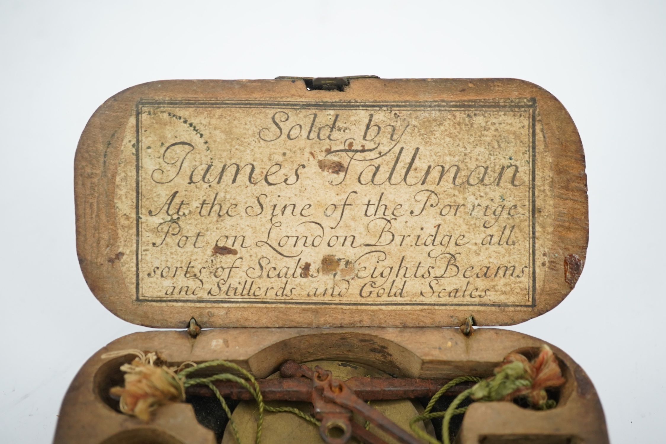 A cased set of late 17th century gold scales labelled for 'James Tallman, At the Sign of the Porridge Pot, on London Bridge, London, all sorts of Scales Weights Beams and Stillerds [sic] and Gold Scales', in original woo